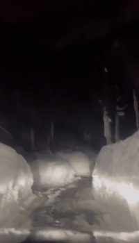 Motorist Drives Between Walls of Snow in Soda Springs, California