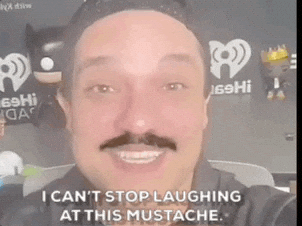 PopCultureWeekly giphyupload pop culture weekly laughing at mustache laughing at his mustache GIF