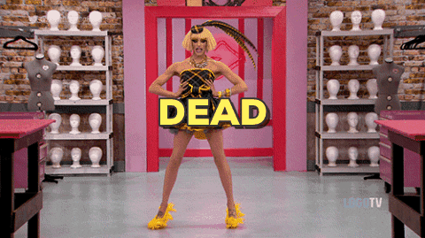 Reality TV gif. A contestant from RuPaul's Drag Race poses for the judges before hitting a dip, a dance move from voguing. They fall backwards on the floor and lay flat with one knee bent, and the text reads, "Dead." 
