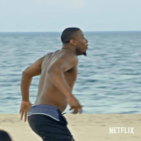 TV gif. In a scene from Love is Blind, we see a sandy beach as two men in bathing suits run up to each other for a chest bump.