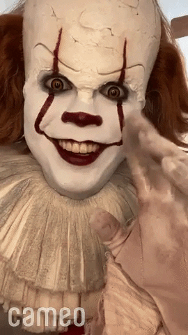 Video gif. Cameo video featuring Pennywise, the clown from the movie It, smiling and gazing at us, waggling his fingers in a creepy way.