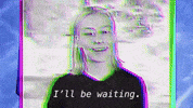 Celebrity gif. Phoebe Bridgers, flashing spottily from within in a stylized, artificial found-footage screen says "I'll be waiiiiiiiting."