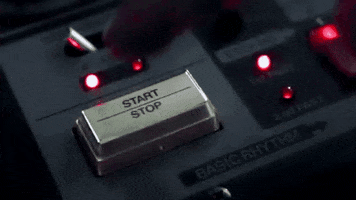 Video gif. A audio engineer presses the stop/start button on their equipment. The video loops endlessly as their finger presses the button.