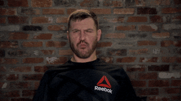 Celebrity gif. MMA fighter Stipe Miocic spreads his arms out wide, mimicking an explosion. He makes sound effects with his mouth.