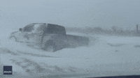 Snow Mound Around Stranded Car Amid During Whiteout Conditions
