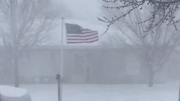 Strong Winds Whip US Flag as Blizzard Conditions Grip Northern Texas