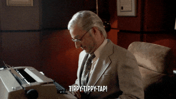 TV show gif. Tony Hale as Leon Wildes, the attorney who represented John Lennon and Yoko Ono in deportation proceedings sits at a desk at types with only his pointer fingers, singing as he taps away, not inspiring a lick of confidence. Caption reads, "Tippy tippy tap!"