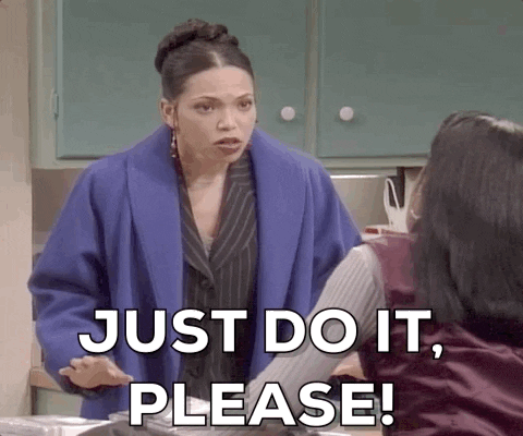 Video gif. A woman in a suit jacket and a long purple wool coat extends her arms with open palms towards the floor, widening her eyes as she says, "Just do it, please," which also appears as text. 