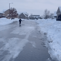 Kid Skates Along Frozen Street to Play Hockey With Friend
