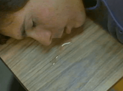 Movie gif. Matthew Broderick as Ferris Bueller from Ferris Bueller's Day Off wakes up dazedly after falling asleep on a classroom desk. He comes face to face with a trail of drool he left behind and frantically wipes the corner of his mouth.