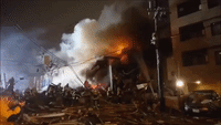 Firefighters Spray Water on Flaming Wreckage Following Sapporo Explosion