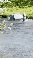 Wind Gust Sends Tent Into River