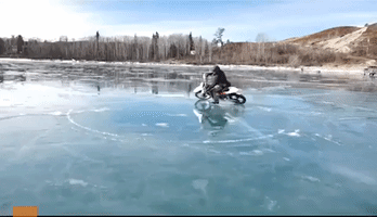 Brave Biker Performs Donuts on Frozen Lake