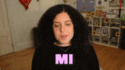 Video gif. Shalymar Rivera seated at a desk in what appears to be a children's room as she records an interview-style video, smiling and speaking in Spanish, "Mi favorita actriz seria Melissa McCarthy."