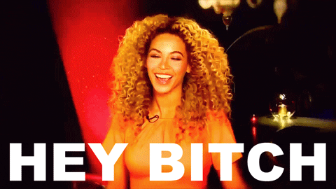 Celebrity gif. Beyonce smiles at us and cocks her head to the side as she says, "Hey bitch," which appears as text.