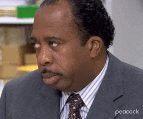 The Office gif. Leslie David Baker as Stanley turns his head and slowly rolls his eyes with the most irritated, tired expression on his face. 