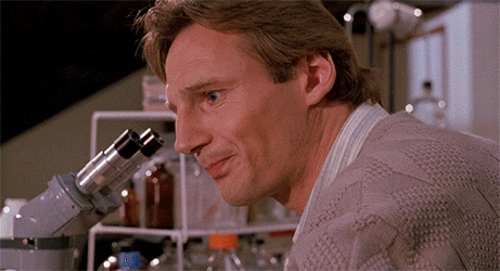 Movie gif. Liam Neeson as Peyton Westlake in Darkman turns away from a microscope with a distant and confused expression on his face. He says, “why? Why? Why? Why?”