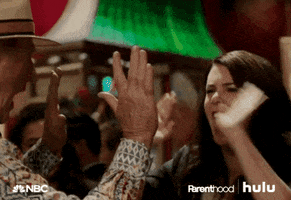 TV gif. Lauren Graham as Sarah Braverman and Craig T Nelson as Zeek Braverman on Parenthood high five over and over with both hands.