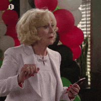 Video gif. Woman shakes her head politely and then looks away cringing a bit as she thinks about what she just heard.