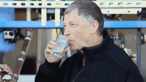 Celebrity gif. Bill Gates drinks from a small glass and nods, smiling at us. 