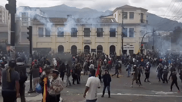Protesters Throw Tear Gas Back at Police Near Ecuador's Legislative Palace in Quito
