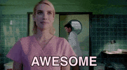 TV gif. Emma Roberts as Chanel Oberlin from Scream Queens is dressed in pink nurse scrubs as she gives a fake smile and says sarcastically, "Awesome," which appears as text.