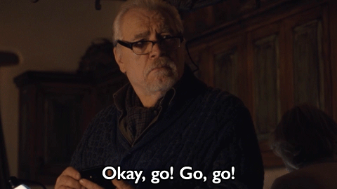 TV gif. Brian Cox as Logan Roy from Succession gestures at someone with his finger to hurry up. Text, "okay, go! Go, go!"