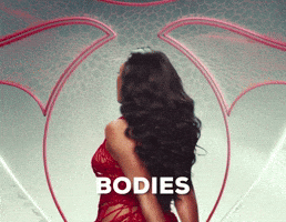 Music video gif. Megan Thee Stallion in her video for Hiss, wearing a lacy red dress, turning over her shoulder to look at us, singing "Bodies on bodies on bodies."