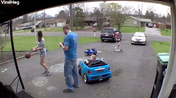 Child Sneaks Up on Dad with Toy Car