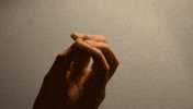 Video gif. Hand with fingers closed to a point expands to reveal a digitally animated translucent geometric webbing connecting the fingers, which waggle and then close again.