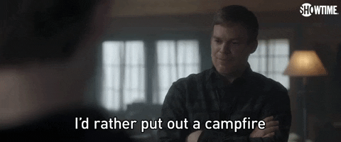 Michael C Hall as Dexter Morgan in Dexter: New Blood stands cross armed and bluntly tells someone, "I'd rather put out a campfire with my face," which appears as text.