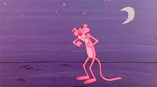 Cartoon gif. Pink Panther is standing in the middle of a vast plain and a crescent moon is out. He stretches out hugely and raises his hand over his head as he yawns.