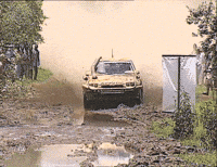 Rally car taking a mud bath