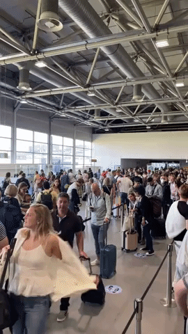 Scores of Passengers Wait at Amsterdam Airport Amid Travel Disruption