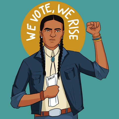 Digital art gif. Native man wearing two long braids and a bolo tie pumps his fist into the sky, a serious look on his face as he holds a ballot in his closed fist, all against a blue background. Text, "We vote, we rise."