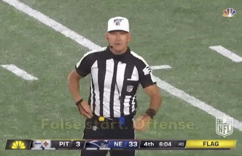 American football referee signalling a false start penalty.