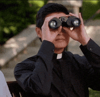 TV gif. Rene Gube as Father Brah in Crazy Ex-Girlfriend peers through binoculars before dejectedly setting them down and saying, "nope...," which appears as text.