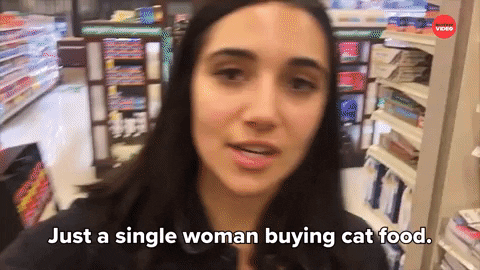 A woman buying cat food
