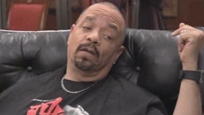 Celebrity gif. Ice-T blinks half asleep on a leather couch, not a thought in his eyes.