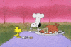 Peanuts gif. Wearing a chef’s hat, Snoopy offers Woodstock one end of the wishbone at the Thanksgiving table. Woodstock smiles and grasps the bone as they struggle to beak it. The bone snaps as Snoopy and Woodstock fly backward, Woodstock with the larger piece.