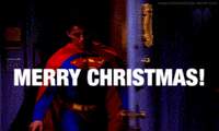 Friends gif. Matt LeBlanc as Joey bursts through the apartment door wearing a Superman costume as he says with a rascally smile, "Merry Christmas!"