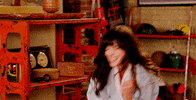 TV gif. Zooey Deschanel as Jessica in New Girl gives an energetic fist pump as she cheers excitedly. 