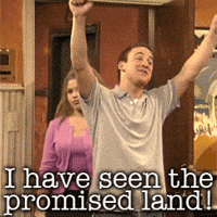 TV gif. Ben Savage as Cory and Danielle Fishel as Topanga on Boy Meets World walk into a room together. Cory holds his arms up victoriously as he excitedly says, “I have seen the promised land!” Topanga embarrassedly stands next to him.