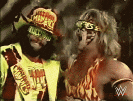 Sports gif. Macho Man and Randy Savage from WWE are standing together and roaring while giving us a thumbs up. 