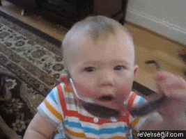 Video gif. Baby grabs sunglasses and slides them on their face while staring at the camera.