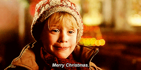 Video gif. Actor Macaulay Culkin as Kevin in Home Alone smiles and says "Merry Christmas."