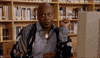 TV gif. Sitting at a computer in a library, Tituss Burgess in Unbreakable Kimmy Schmidt bats his eyes then looks away in boredom.