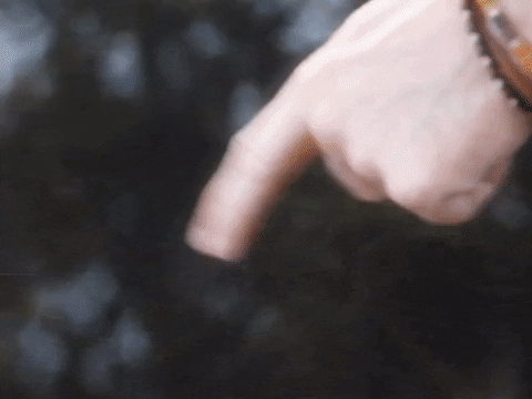 A finger tapping water and the ripples turn into a reflection of a black cat with the caption 