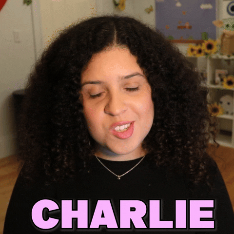 Video gif. Shalymar Rivera Gonzalez looks at us with a smile and says, "Charlie Chaplin," which appears as text. 