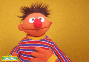 Muppets gif. Ernie on Sesame Street smiles and nods pointing upward as if he has an idea.
